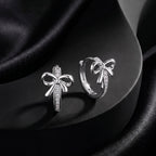 Bow Moissanite Huggie Earrings — product and styling view