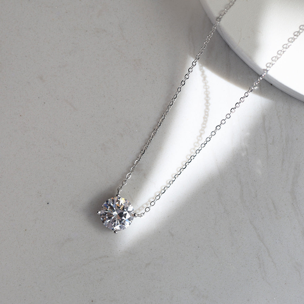 Four Prong Round Moissanite Solitaire Necklace — product and styling view